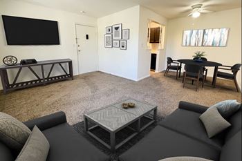 A living room with a couch and a table and a television